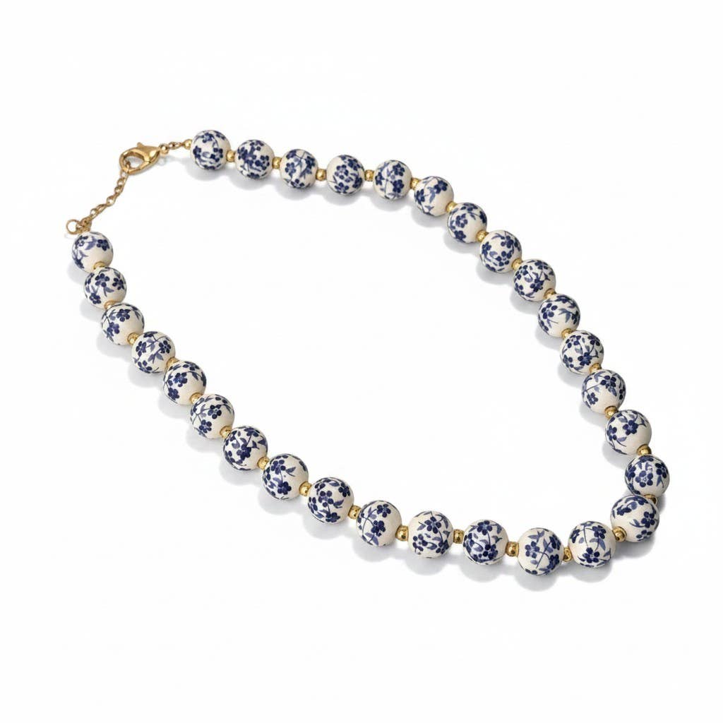 Collar Sakura. Acero inoxidable chapado en oro 14K y cerámica